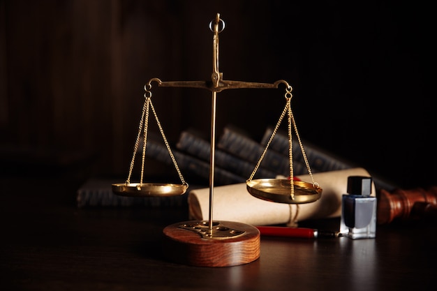 Attorney and notary concept. Wooden gavel on the table and libra.