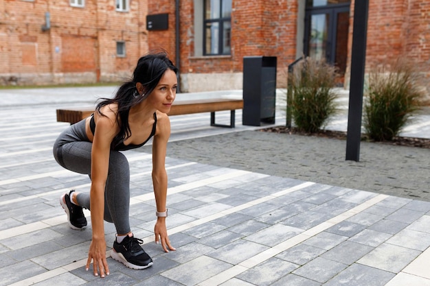 Attractive adult woman getting ready for street jogging