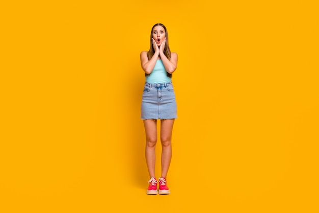 Attractive amazed girl isolated over yellow color background