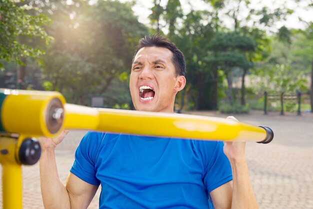 Attractive asian man doing working out