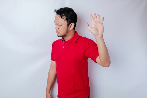 Attractive Asian man with hand gesture pose rejection or prohibition with copy space