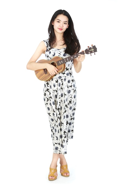 Attractive asian woman playing ukulele