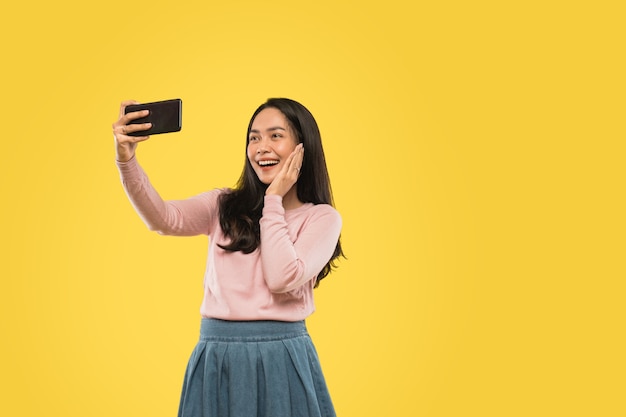 Attractive asian woman selfie using a smartphone