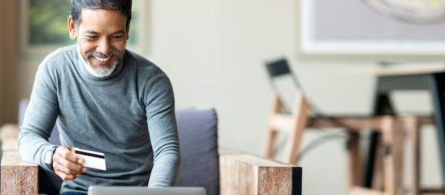 Attractive bearded hipster asian father or Hispanic old man using Laptop