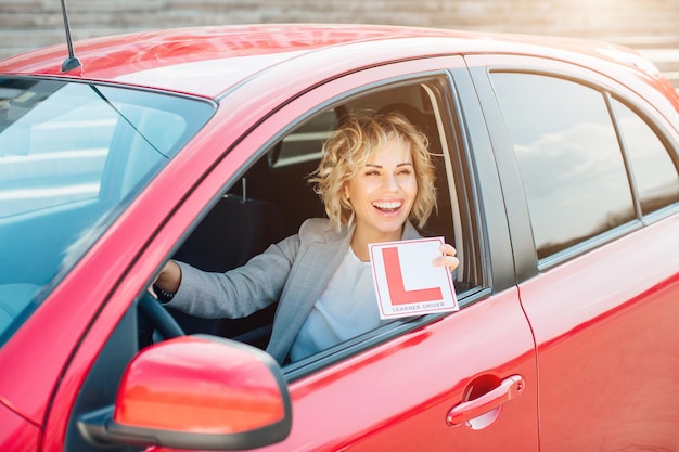 Attractive blonde in a car showing keys