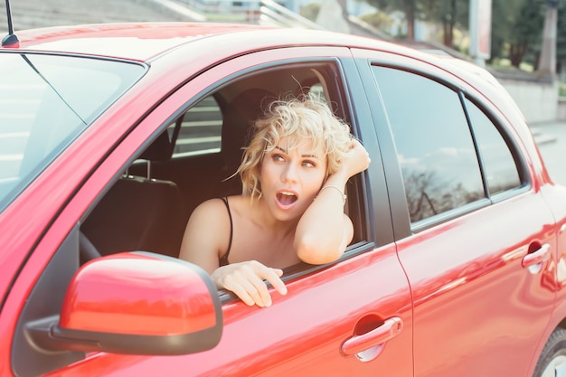 Attractive blonde in a car showing keys