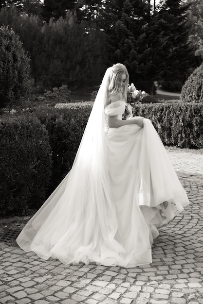 attractive bride in traditional dress with wedding bouquet