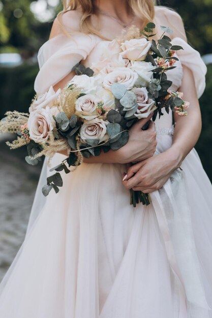 attractive bride in traditional dress with wedding bouquet