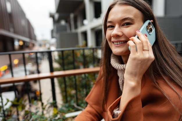 Attractive brunette businesswoman talking on mobile phone in the street