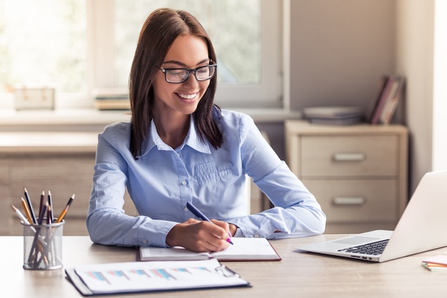 Attractive business lady in formal clothes and eyeglasses.