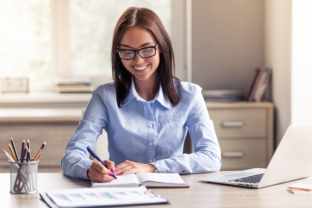 Attractive business lady in formal clothes and eyeglasses.