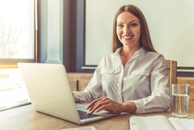 Attractive business lady working on laptop