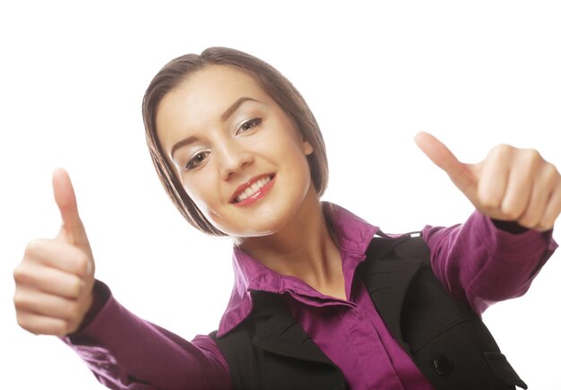 Attractive business woman giving thumbs up