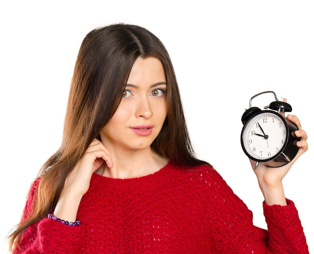 Attractive businesswoman holding alarm clock