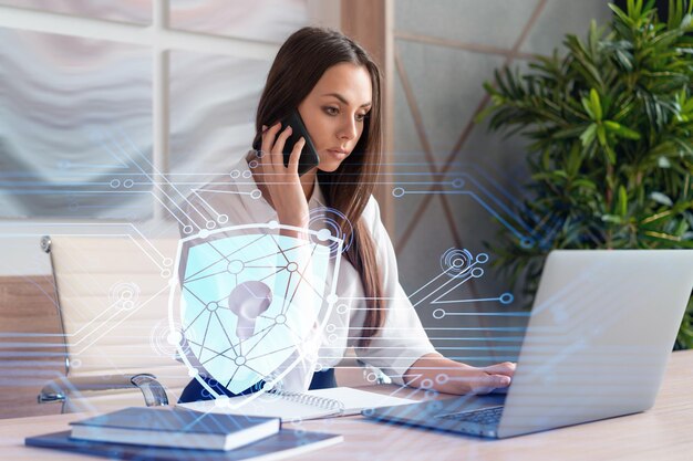 Attractive businesswoman in white shirt has conference call of cyber security in compliance division to protect clients confidential information IT hologram lock icons over office background