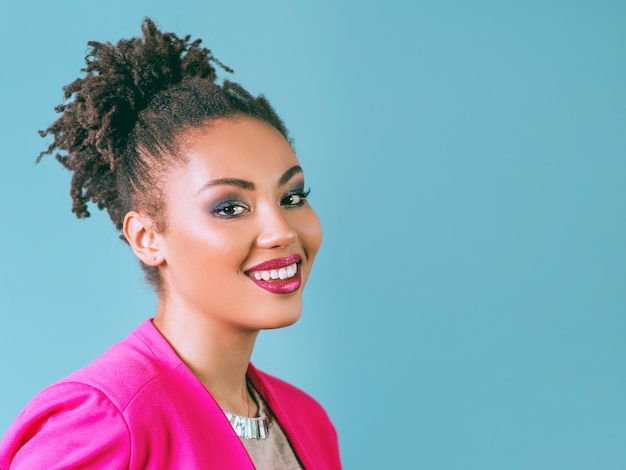 attractive cheerful smiling young woman mixed rase in pink blazer