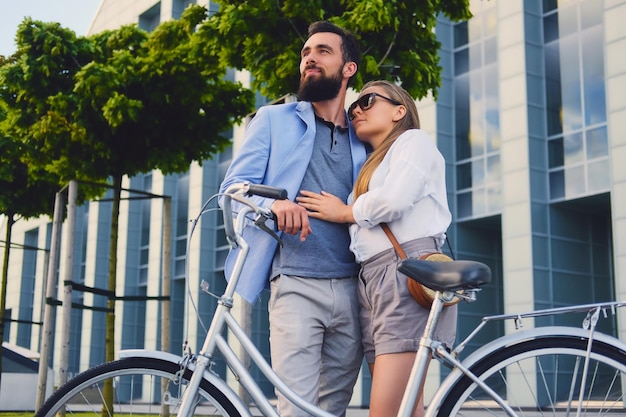 Attractive couple on a date after bicycle ride in a city.