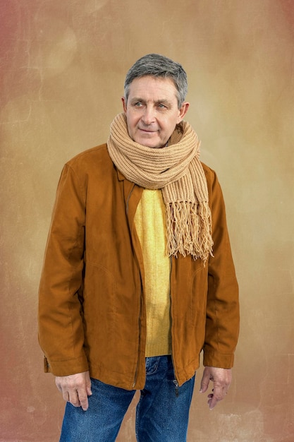 Attractive elderly man elegantly dressed in sweater jacket and scarf