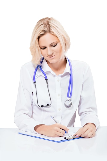 Attractive female doctor sitting and writing isolated