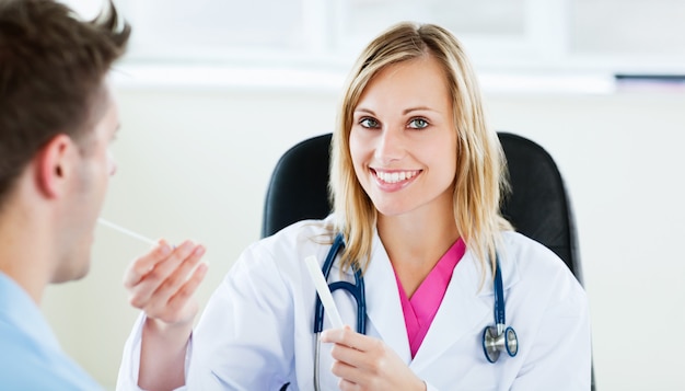 Attractive female doctor taking patient