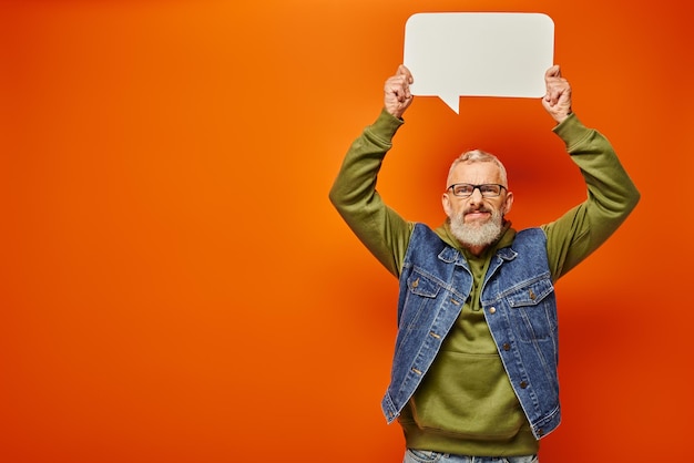 attractive funky mature male model in green hoodie posing with speech bubble and looking at camera