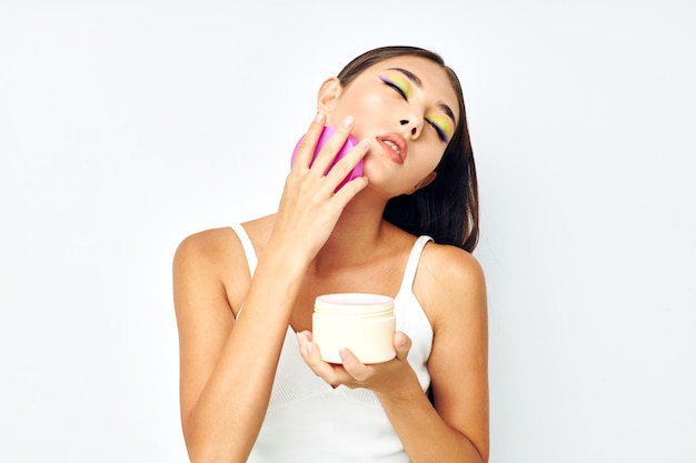 Attractive girl posing cream jar cosmetics isolated background unaltered