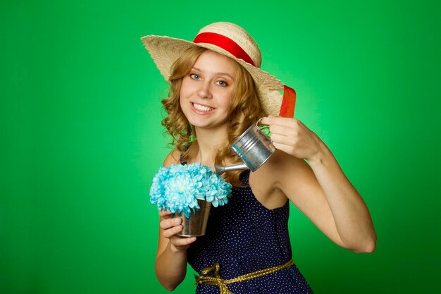 Attractive girl watering flowers