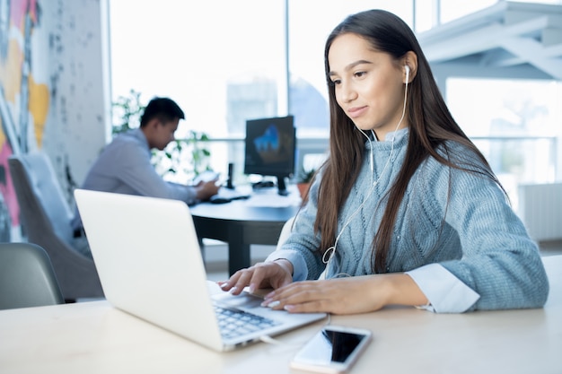 Attractive lady in contemporary open space office