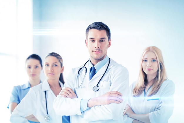 attractive male doctor in front of medical group