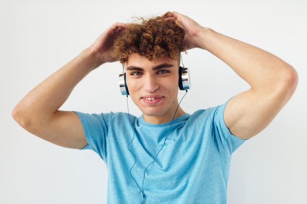 Attractive man in blue tshirts headphones fashion isolated background