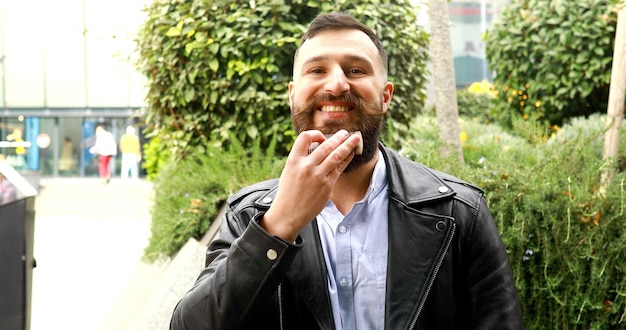 Attractive man comb hair. Hipster care his beard.