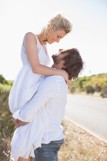 Attractive man lifting up his girlfriend