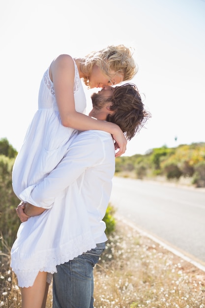 Attractive man lifting up his pretty girlfriend 