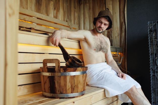 Attractive man relaxing in Finnish sauna