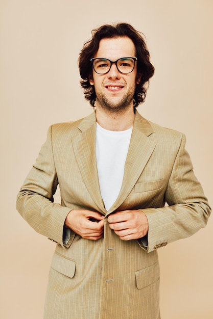 Attractive man spectacled beige suit elegant style beige background. High quality photo