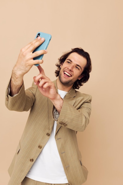 Attractive man takes a selfie classic style technologies isolated background