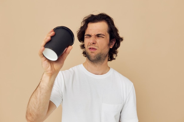 Attractive man with a black glass in a white tshirt isolated background