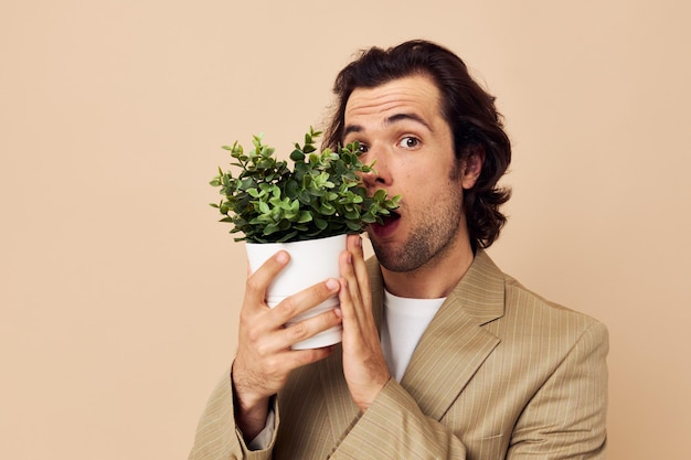 Attractive man with a flower pot in his hands classic style isolated background