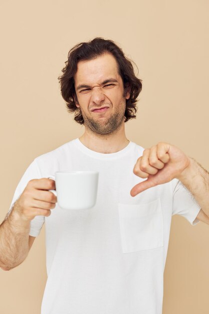 Photo attractive man with a white mug in his hands emotions posing isolated background