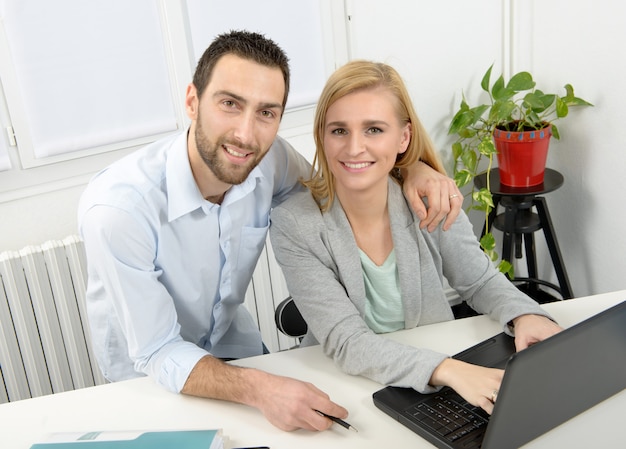 Attractive man and woman business using laptop computer