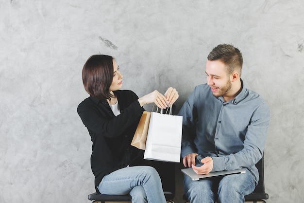 Attractive man and woman with shopping bags