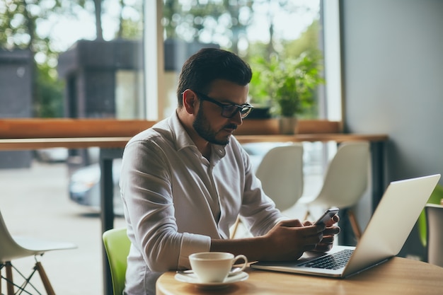 Attractive man working in cafe