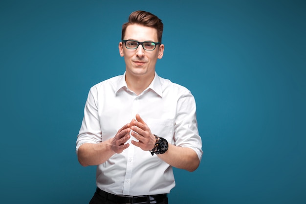 Attractive mature businessman in costly watch, black glasses and white shirt 