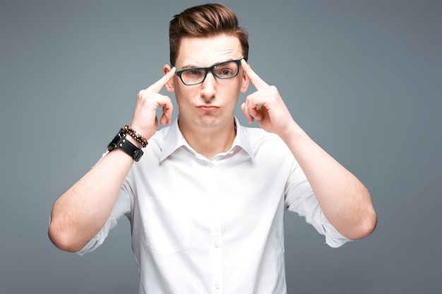 Attractive mature businessman in costly watch, black glasses and white shirt 