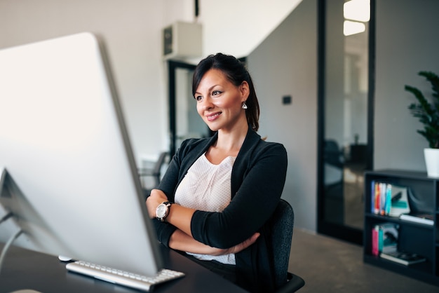 Attractive office worker sitting at desk.