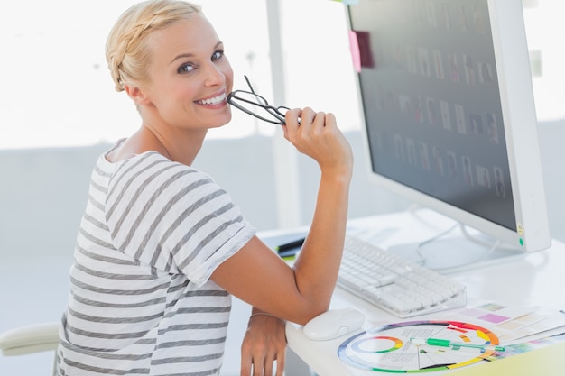 Attractive photo editor at her desk