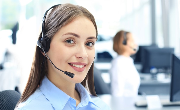 Attractive positive young businesspeople and colleagues in a call center office