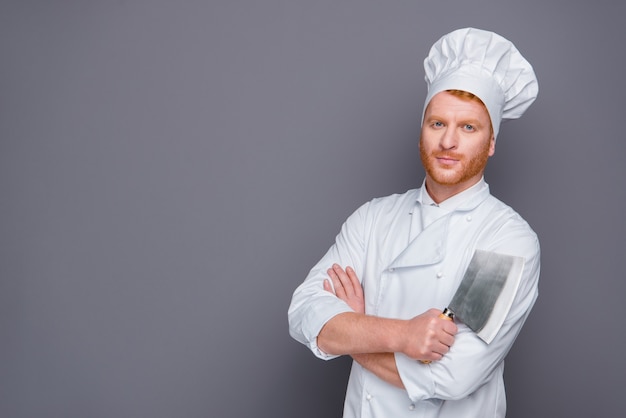 Attractive redhead chef posing in his uniform