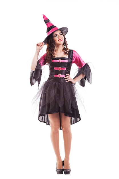 Attractive  smiling young brunette woman dressed as a witch