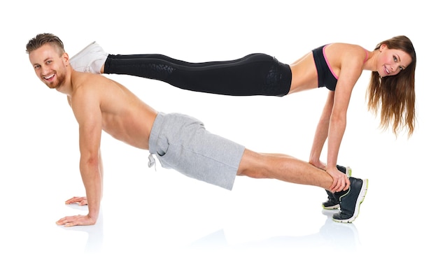 Attractive sport couple man and woman doing fitness exercises on the white background